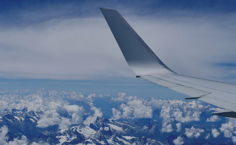 view from the airplane window to the mountains, wing of the aircraft