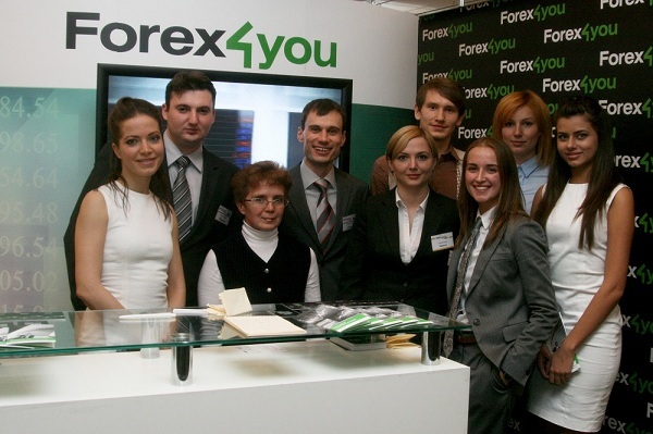 Forex4you representatives standing next to company's stand at Moscow expo in 2011